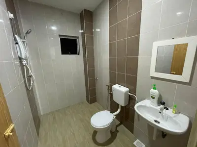 a bathroom with a toilet and a sink at No 61 Nazirin Homestay Tmn Indah Raya 2 Manjung Lumut in Lumut