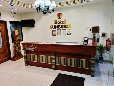 a hotel lobby with a hotel sun strings sign on the wall at Hotel Sun Birds in Cameron Highlands