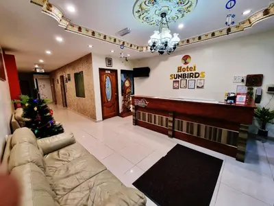 a lobby of a hotel with a christmas tree in it at Hotel Sun Birds in Cameron Highlands