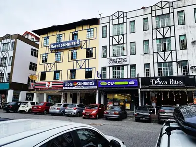 a group of cars parked in front of a building at Hotel Sun Birds in Cameron Highlands