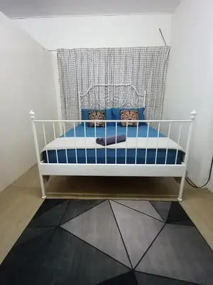 a white crib with blue pillows in a room at Minimalist Shop Stay @ Royal Town in Kuala Kangsar