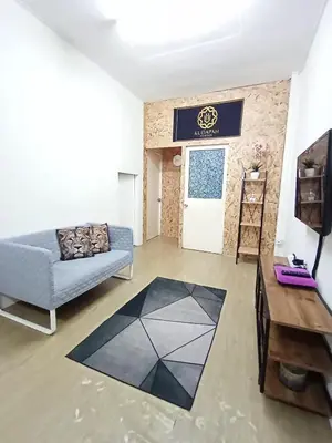 a living room with a couch and a table at Minimalist Shop Stay @ Royal Town in Kuala Kangsar