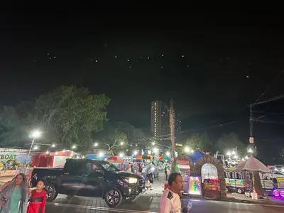 a group of people walking around a market at night at Beach Resort 19 Home Stay SRI SAYANG APARTMENT BATU FERRINGHI 3BEDROOM in Batu Ferringhi