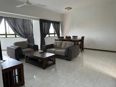 a living room with two couches and a table at Beach Resort 19 Home Stay SRI SAYANG APARTMENT BATU FERRINGHI 3BEDROOM in Batu Ferringhi