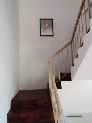 a staircase in a house with a picture on the wall at Pinang Beach Cottage @ Ferringhi in Batu Ferringhi