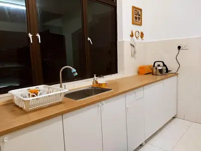 a kitchen counter with a sink and a mirror at Pinang Beach Cottage @ Ferringhi in Batu Ferringhi