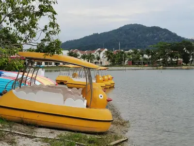 a yellow rubber duck boat in the water at Marina Island Lumut HomeHotel in Lumut