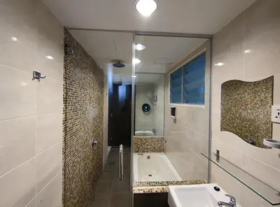 a bathroom with a tub and a sink and a shower at Marina Island Lumut HomeHotel in Lumut
