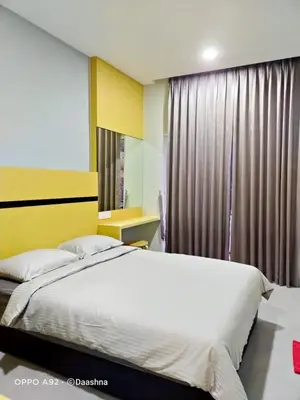 a bedroom with a large bed and a window at CAMERON TROPICA HOMESTAY in Cameron Highlands