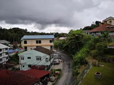 an aerial view of a town with houses and a road at CAMERON TROPICA HOMESTAY in Cameron Highlands
