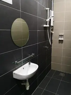 a bathroom with a sink and a mirror at CAMERON TROPICA HOMESTAY in Cameron Highlands