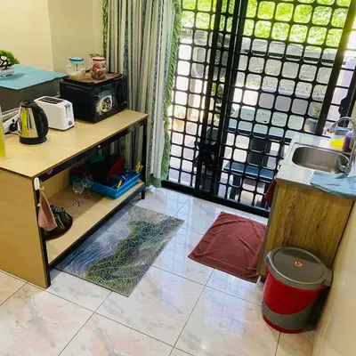 a kitchen with a counter and a sink in a room at 100 Oastel coLiving in Tanah Rata