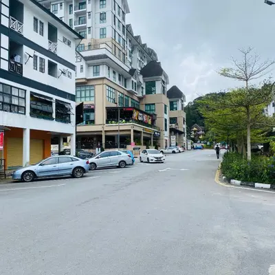 a city street with cars parked on the street at 100 Oastel coLiving in Tanah Rata