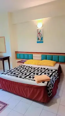 a large bed in a room with at Lumut Valley in Lumut