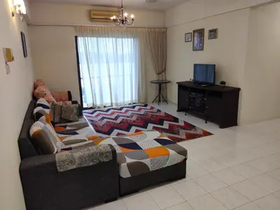 a living room with a couch and a tv at Lumut Valley in Lumut