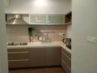 a kitchen with green and white cabinets and a sink at Lumut Valley in Lumut
