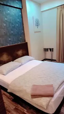 a bedroom with a large bed with a large window at Lumut Valley in Lumut
