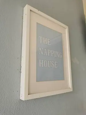 a picture in a white frame hanging on a wall at Cozy NEAR-BEACH Apartment ~The Napping House \u6d77\u6ee8\u516c\u5bd3~ in Batu Ferringhi