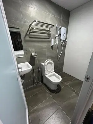 a bathroom with a toilet and a sink at OU INN Cameron Highlands ,Ferm Nyonya Restaurant in Tanah Rata