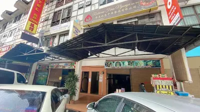 a building with cars parked in front of it at OU INN Cameron Highlands ,Ferm Nyonya Restaurant in Tanah Rata
