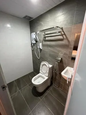 a bathroom with a toilet and a sink at OU INN Cameron Highlands ,Ferm Nyonya Restaurant in Tanah Rata