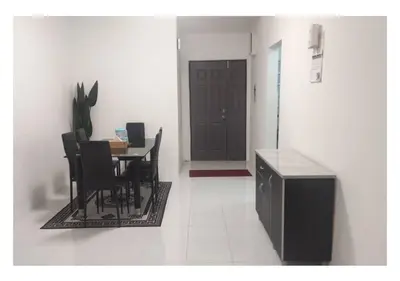 a dining room with a table and chairs and a door at EMERALD MUSLIM HOMESTAY CAMERON HIGHLANDS in Cameron Highlands