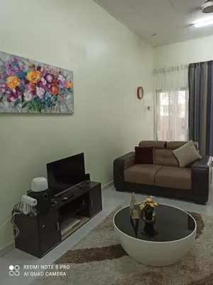 a living room with a couch and a tv at Taiping Desa Jana Home Stay in Kamunting