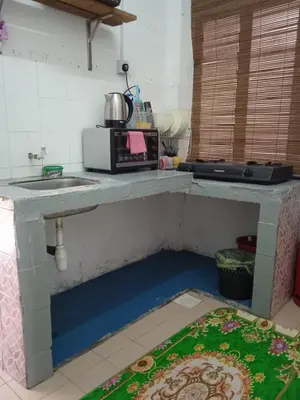 a kitchen with a counter top with a sink and a counter top at Budget Homestay Impiana Adril in Ipoh