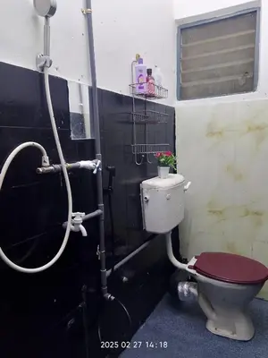 a bathroom with a toilet and a shower at Budget Homestay Impiana Adril in Ipoh