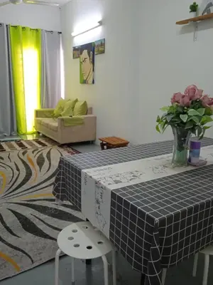 a living room with a table and a couch at Budget Homestay Impiana Adril in Ipoh