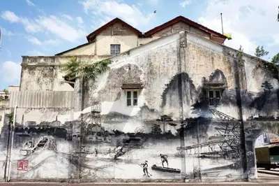 an old building with a mural on the side of it at Budget Homestay Impiana Adril in Ipoh