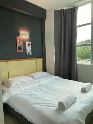 a bedroom with a large bed with two towels on it at Fresh Hotel Falim in Ipoh