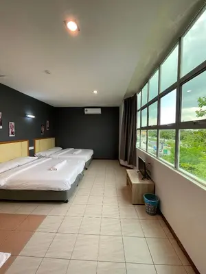 two beds in a large room with large windows at Fresh Hotel Falim in Ipoh