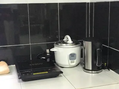 a slow cooker sitting on top of a kitchen counter at Kinaz homestay in Ipoh