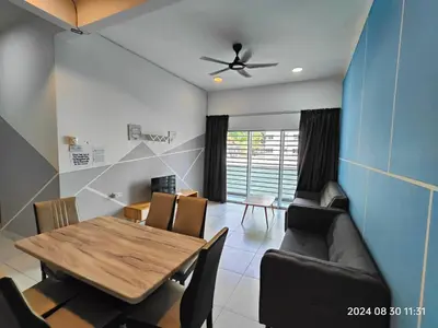 a dining room with a wooden table and chairs at Cameron Homestay in Tanah Rata