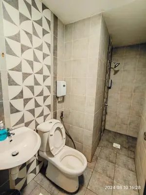 a bathroom with a toilet and a sink at Cameron Homestay in Tanah Rata