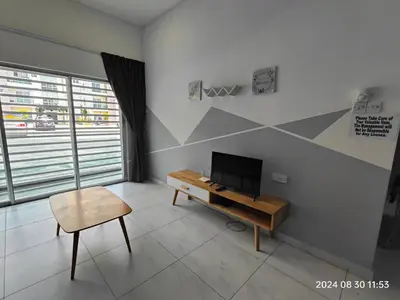 a living room with a tv and a chair at Cameron Homestay in Tanah Rata