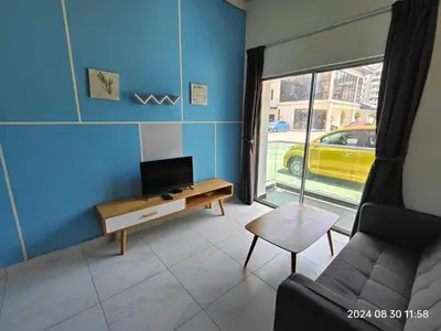 a living room with a couch and a tv at Cameron Homestay in Tanah Rata