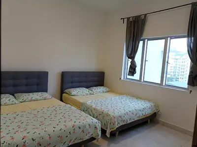 a bedroom with two beds and a window at Cameron Homestay @ Quintet in Tanah Rata