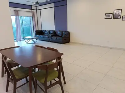 a living room with a table and chairs and a couch at Cameron Homestay @ Quintet in Tanah Rata
