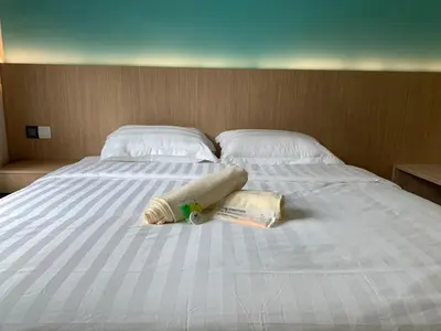 a bed with a towel and a stuffed animal on it at M Quality Hotel in Gua Musang