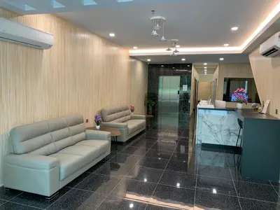 a waiting room with two couches and a counter at M Quality Hotel in Gua Musang