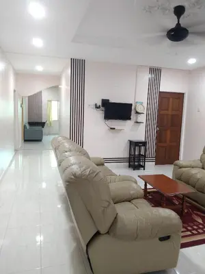a living room with a couch and a table at Casa Villa Homestay Sekinchan in Sekincan