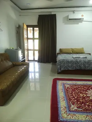 a living room with a couch and a bed at Denai Senja in Kuala Selangor