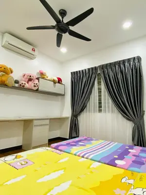 a bedroom with a bed and a ceiling fan at Shuang Yang Sekinchan Homestay 3 in Sekincan