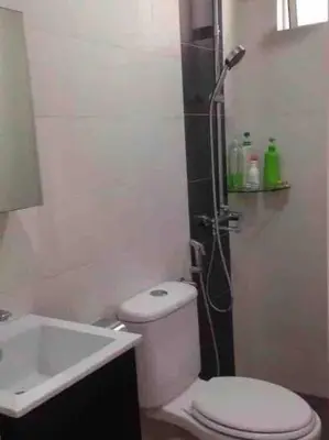 a bathroom with a shower and a toilet and a sink at Shuang Yang Sekinchan Homestay 3 in Sekincan