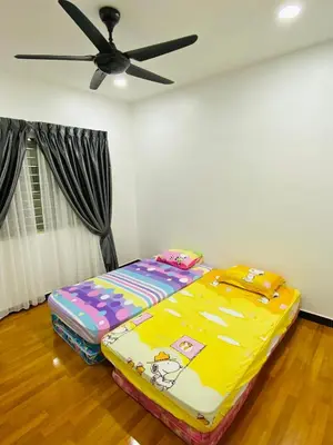 a bed in a room with a ceiling fan at Shuang Yang Sekinchan Homestay 3 in Sekincan