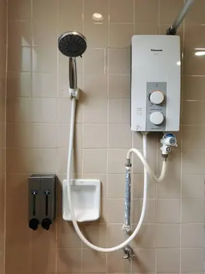 a shower in a bathroom with a urinal at Cozy NEAR-BEACH Apartment - LazyCats' Den in Batu Ferringhi