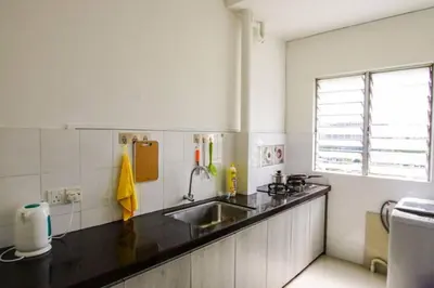 a kitchen with a sink and a counter top at Palm Court in Tanjong Tokong