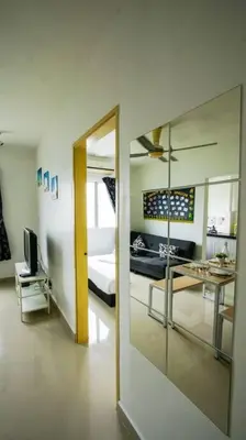 a room with a bedroom with a bed and a mirror at Palm Court in Tanjong Tokong